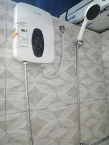 a bathroom with a hair dryer on a wall at Posada Shumac Ñahui baño privado y ducha caliente in Huaraz