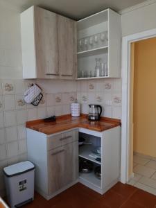 a kitchen with white cabinets and a wooden counter top at Bahía Inglesa arenas blancas y aguas turquesa in Caldera