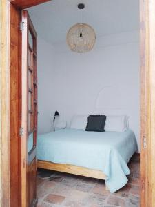a bedroom with a bed and a chandelier at Casita de Piedra in Bogotá