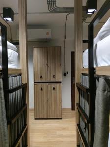 a room with two bunk beds and a wooden door at N5 Ratchawong Hostel in Bangkok
