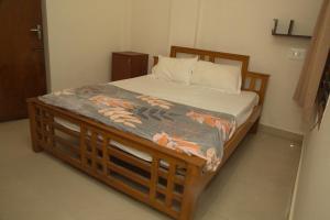 a bed in a room with a wooden bed frame at IZI APOLLO STAY in Chennai
