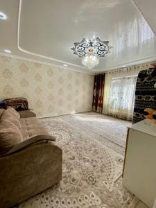 a bedroom with a bed and a chandelier at GreenHouse in Naryn