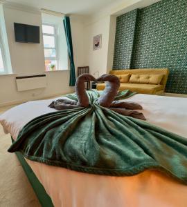 a bedroom with a bed with a towel animal on it at Serene Ocean Side Apartment BTN in Brighton & Hove