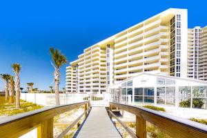 a boardwalk leading to a large building on the beach at Perdido Sun 1104 in Perdido Key