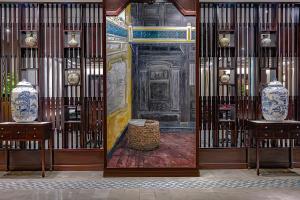 a gate with a door with two vases on it at Wyndham Garden Hoi An Cua Dai Beach in Hoi An