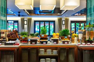 a buffet line with fruits and vegetables on display at Wyndham Garden Hoi An Cua Dai Beach in Hoi An
