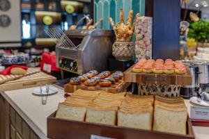 a bakery with bread and pastries on a counter at Wyndham Garden Hoi An Cua Dai Beach in Hoi An