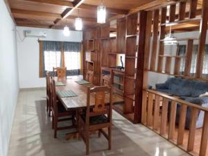 a dining room with a table and a bed at La Maison Du Voyageur in Kribi