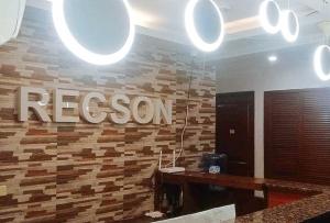 a room with a regson sign on a wall at RedDoorz @ Recson Hostel Coron Palawan in Coron