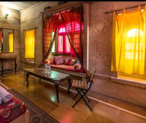 a living room with a couch and a table at Hotel Oasis Haveli in Jaisalmer