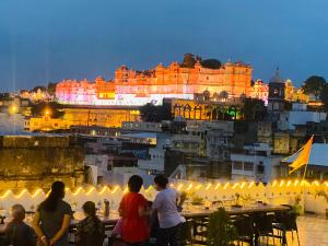 a group of people standing in front of a building at night at Kotra Haveli A Boutique Hotel by Lake Pichola in Udaipur