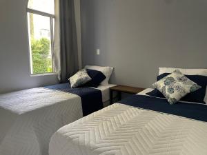 a bedroom with two beds and a window at Exclusivo apartamento in San Salvador