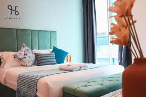 a bedroom with a bed with pillows on it at Homesuite' Home at Sutera Avenue in Kota Kinabalu +120 photos