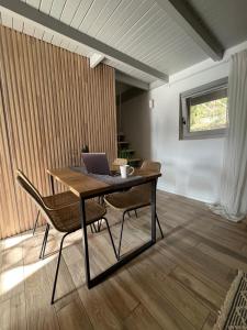 a dining room with a table with a laptop on it at Fotel home in Csókakő