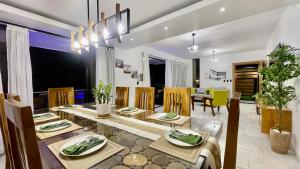 a dining room and living room with a table and chairs at The Grand Chalet in Jarabacoa