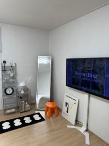 a room with a flat screen tv on a wall at M Stay Near Mokdong Station in Seoul