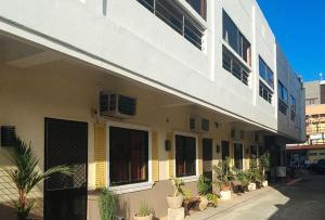 a building with potted plants on the side of it at RedDoorz near Colgante Bridge Naga City in Naga