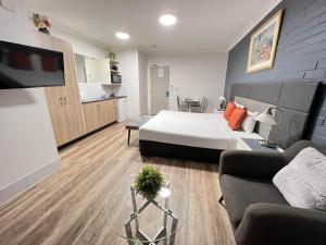 a hotel room with a bed and a living room at Benson Court Motel in Brisbane