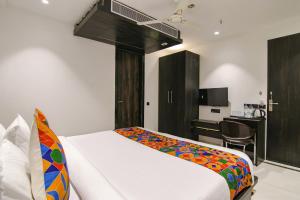 una camera d'albergo con letto e scrivania di FabHotel Greysky a Nuova Delhi
