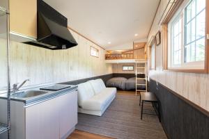 a kitchen and living room in a tiny house at Hotel Japan Shiga in Yamanouchi