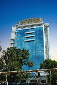 a tall glass building with a tree in front of it at The Zabeer Jashore in Jessore