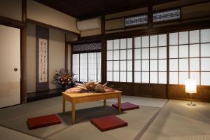 a room with a table in a room with windows at moku杢 in Miyazu