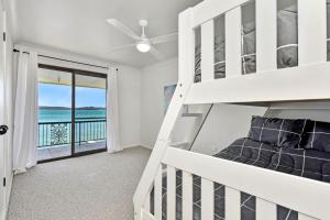 a bedroom with a bunk bed and a balcony at New Property Silverwater Serenity Shores Absolute Waterfront On The Lake in Bonnells Bay