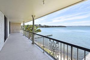 a balcony with a view of the water at New Property Silverwater Serenity Shores Absolute Waterfront On The Lake in Bonnells Bay