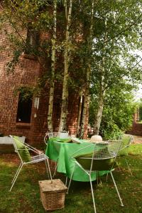 a green table and chairs in front of a brick building at Sebakwe in Dullstroom