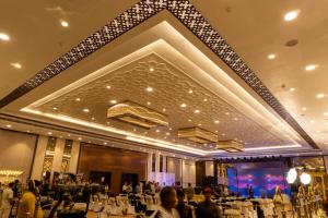 a banquet hall with people sitting at tables at Palm Resorts in Tinsukia