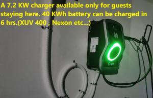 a green charger on a wall with a hose at White Petals -3 BHK Homestay Munnar - Available For Indian Nationals Only in Munnar