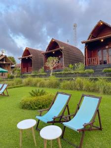 a group of chairs and tables in front of a house at Pinggan caldera in Baturaja