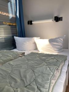 an unmade bed with two pillows at Hausboot Celina in Werder
