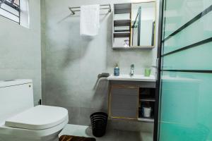a bathroom with a toilet and a sink at Sky Oasis Home in Nairobi