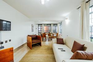 a living room with a couch and a table at Sky Oasis Home in Nairobi