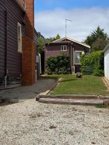 a house with a yard next to a building at R&R Blue Diamond Luxury Studio Maryborough, Vic in Maryborough