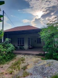 a small white house with a red roof at Sya Al-Yahya Homestay in Kuala Terengganu