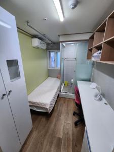 a small room with a bed and a desk at Gangnam Best Dormitory in Seoul