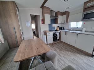 a kitchen with a wooden table and a wooden counter top at Caravan in Jaywick,Jaywick sand, Clacton-on-sea in Jaywick Sands