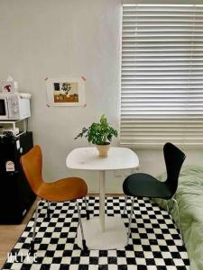 a table and two chairs in a room at Tolerance in Incheon