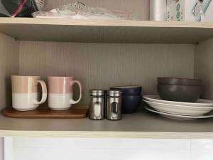 a shelf with cups and plates and bowls on it at Tolerance in Incheon