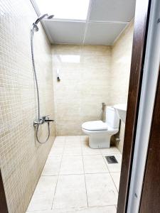 a bathroom with a toilet and a shower at Ras Star Residence - Home Stay in Dubai