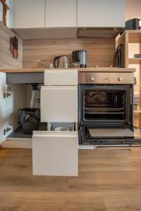 a kitchen with an open oven in a kitchen at Cozy Tyrolean Old Town Studio in Hall in Tirol