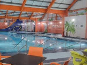 a large swimming pool with a table and chairs at Caravan in Jaywick,Jaywick sand, Clacton-on-sea in Jaywick Sands