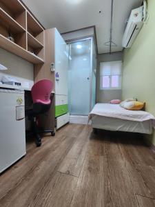 a room with a bed and a desk and a chair at Gangnam Best Dormitory in Seoul