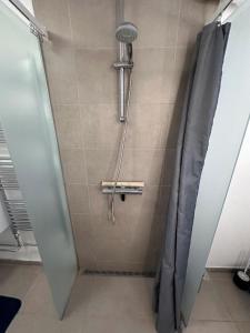 a shower in a bathroom with a shower curtain at Nice apartment in Odense in Odense