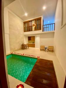 a house with a swimming pool in the middle of a room at Noah Villa and Chapel in Jimbaran