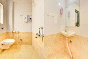a bathroom with a toilet and a sink and a shower at FabExpress Sky Inn in Pune