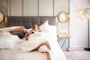 a woman laying in bed with a man at eva,VILLAGE in Saalbach-Hinterglemm