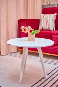 a white table with flowers on it in a living room at Kilimanjaro poa in Moshi